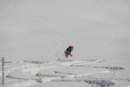 Ski, Snowboard freeride i deep powder snow. Gudauri Georgia Caucasus resort. Freeride in Caucasus mountains. Freeride snowboarding in winter. Heliboarding freeride. Riding in powder on snowborad. photo