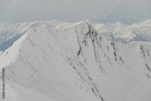 Ski, Snowboard freeride i deep powder snow. Gudauri Georgia Caucasus resort. Freeride in Caucasus mountains. Freeride snowboarding in winter. Heliboarding freeride. Riding in powder on snowborad. photo