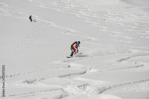 Ski, Snowboard freeride i deep powder snow. Gudauri Georgia Caucasus resort. Freeride in Caucasus mountains. Freeride snowboarding in winter. Heliboarding freeride. Riding in powder on snowborad. photo