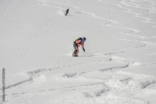 Ski, Snowboard freeride i deep powder snow. Gudauri Georgia Caucasus resort. Freeride in Caucasus mountains. Freeride snowboarding in winter. Heliboarding freeride. Riding in powder on snowborad. photo