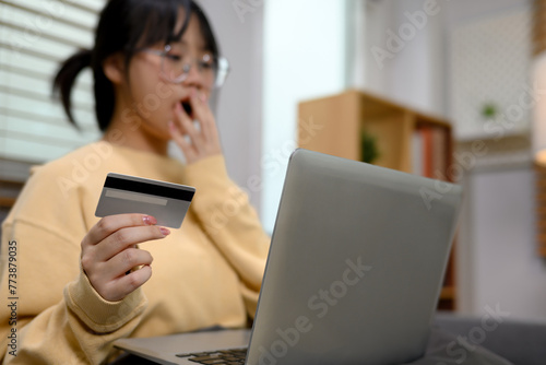 Portrait of young woman making orders via the Internet on digital tablet or paying by credit card