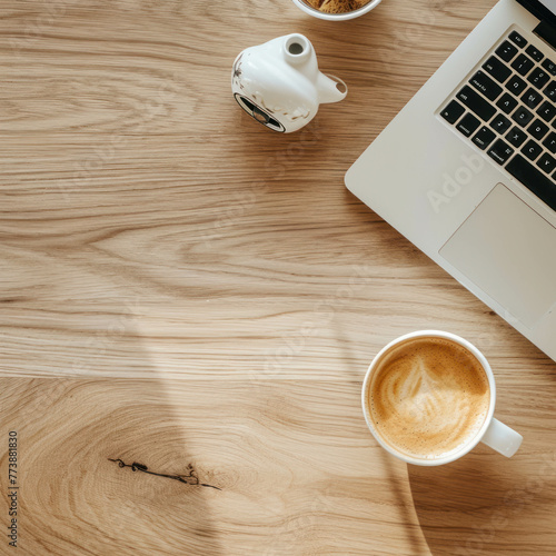 Discover a minimalist workspace from a bird's eye view, featuring a light wooden tabletop, a laptop, and a cup of coffee. Zoomed in to capture every detail. AI generative . photo