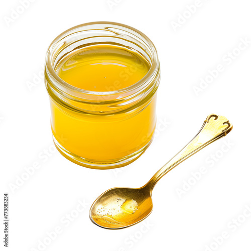 An artisan jar of ghee, with a golden spoon resting beside it, showcasing this clarified butter’s rich culinary heritage, isolated on transparent background photo