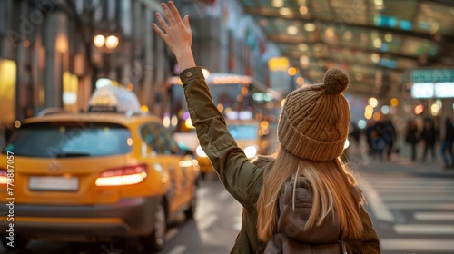 Girl dressed autumn outfit calling yellow taxi cab raising arm waving gesture in the city airport arrival zone. Traveling, airport transfer after arriving and city piblic transport concept. photo