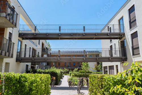 Residential Buildings Apatment Blocks with Bridge Between Houses and Garden Landscape in Modern Green City. New Eco Modern Residential Housing.   photo