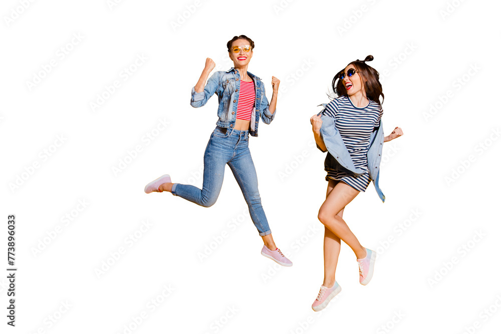 Full legs body size two dreamy charming lovely cute sweet lady in glasses spectacles cool trendy street style stylish casual denim jeans wear raised fists up isolated on yellow vivid background - obrazy, fototapety, plakaty 