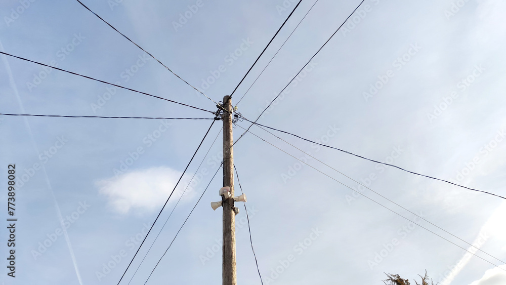 Old pole with wires against the sky. Electric transmission line. Eco-friendly energy Old pole with wires against the sky. Electric transmission line. Eco-friendly energy