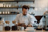 Contemplative chef researching coffee varieties on a tablet in a minimalist café kitchen