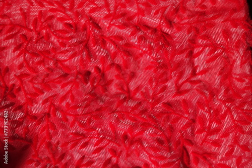 Surface of semi-transparent scarlet red burnout velvet fabric