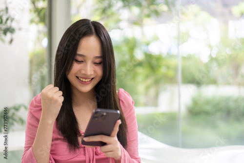 Smiling young woman enjoying a relaxing while browsing her smartphone, lifestyle, connectivity, online interaction, leisure time, and joy of everyday moment, social media engagement, remote working