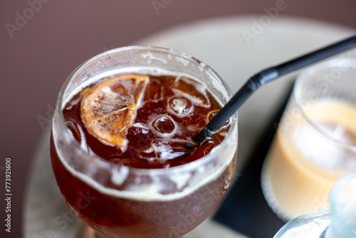 selective focus, cool, fizzy drinks with ice Craft cola with white foam Decorate with a lemon slice on top. A refreshing drink made from herbs. At the Chiang Mai cafe