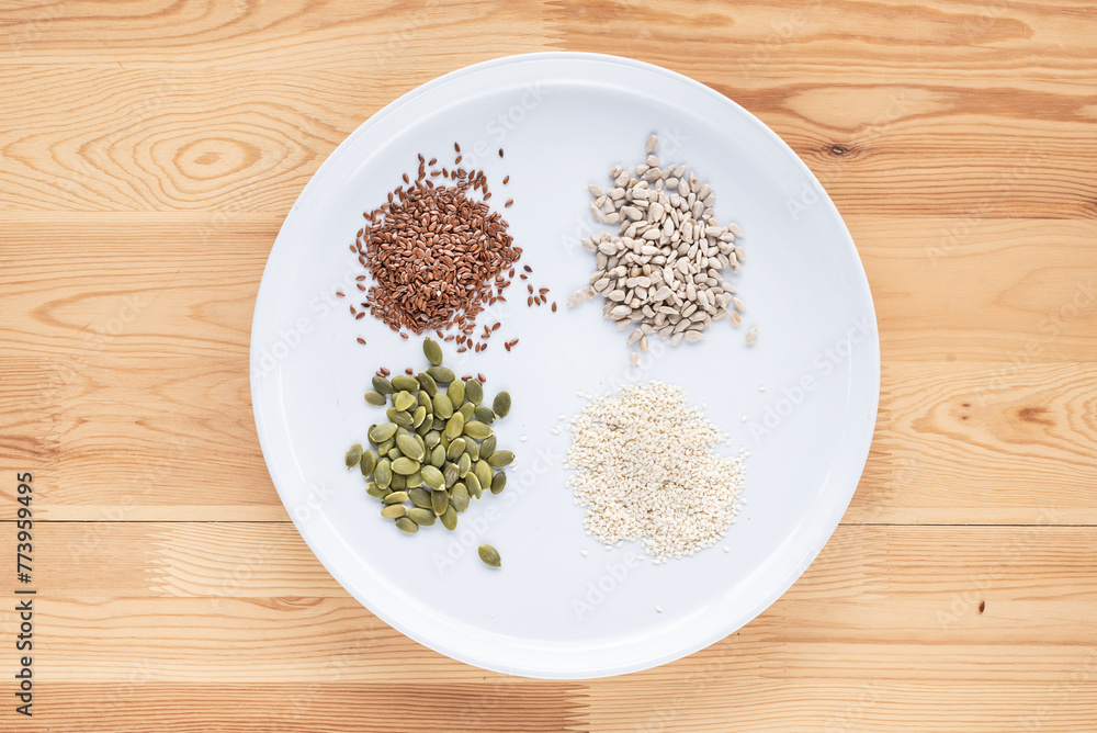 Seed cycling for hormone balance, to balance pre and post menopausal hormones. Flax, pumpkin, sesame and sunflower seeds. Balancing hormones - estrogen and progesterone. Woman health, fertility Seed cycling for hormone balance, to balance pre and post menopausal hormones. Flax, pumpkin, sesame and sunflower seeds. Balancing hormones - estrogen and progesterone. Woman health, fertility