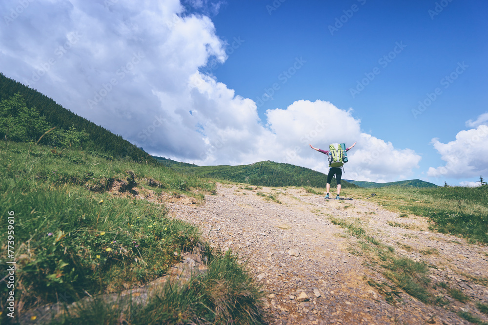 Active lifestyle. Traveling, hiking and trekking concept. Young woman with backpack in the Carpathian mountains.