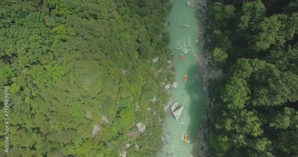top view of rafters rafting along a picturesque river surrounded by forests top view of rafters rafting along a picturesque river surrounded by forests