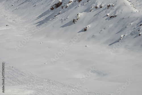 Freeride rally traces on powder snow. Aerial drone view of Gudauri ski resort in winter. Caucasus mountains in Georgia. Kudebi, Bidara, Sadzele, Kobi aerial panorama in caucasus winter mountains.