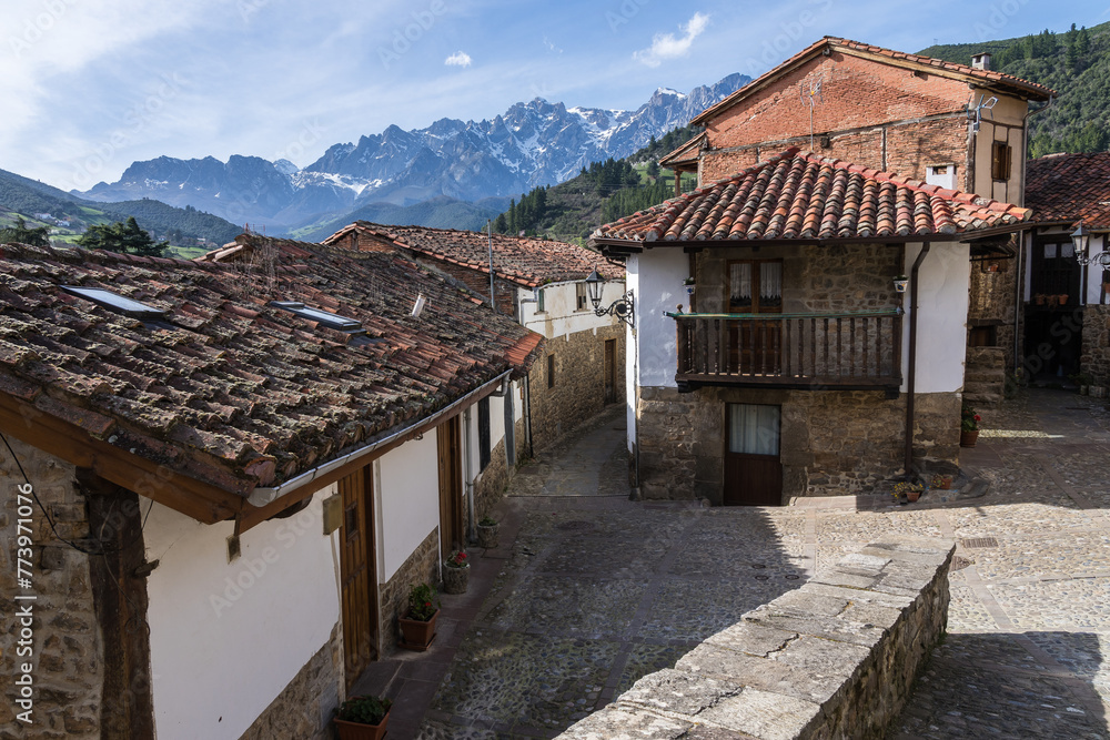 Traditional stone houses in Potes with mountain backdrop Traditional stone houses in Potes with mountain backdrop