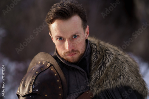 Prtrait medieval knight with sword in armor as style Game of Thrones in winter forest