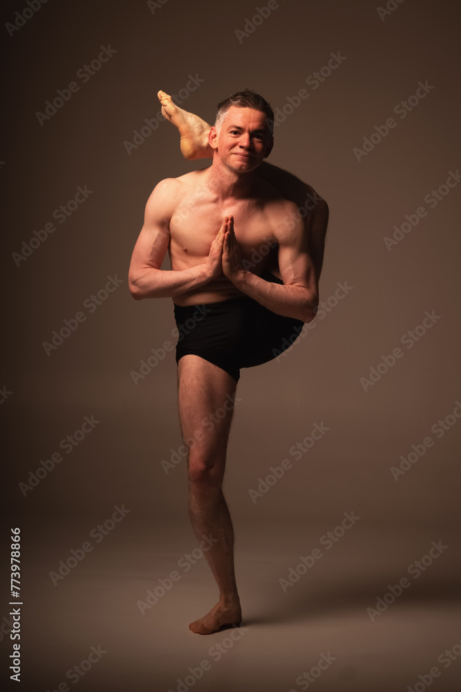 Durvasasana, Ashtanga yoga Side view of man wearing sportswear doing Yoga exercise against white background. Durvasasana, Ashtanga yoga Side view of man wearing sportswear doing Yoga exercise against white background.