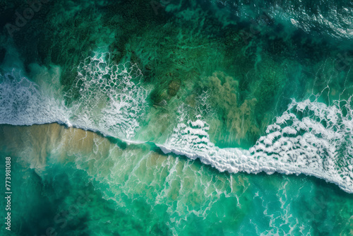 Overhead perspective of ocean waves crashing against the shore