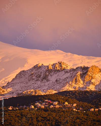 Views of Sierra Nevada from Granada during the golden hour at sunset with the peaks full of snow.