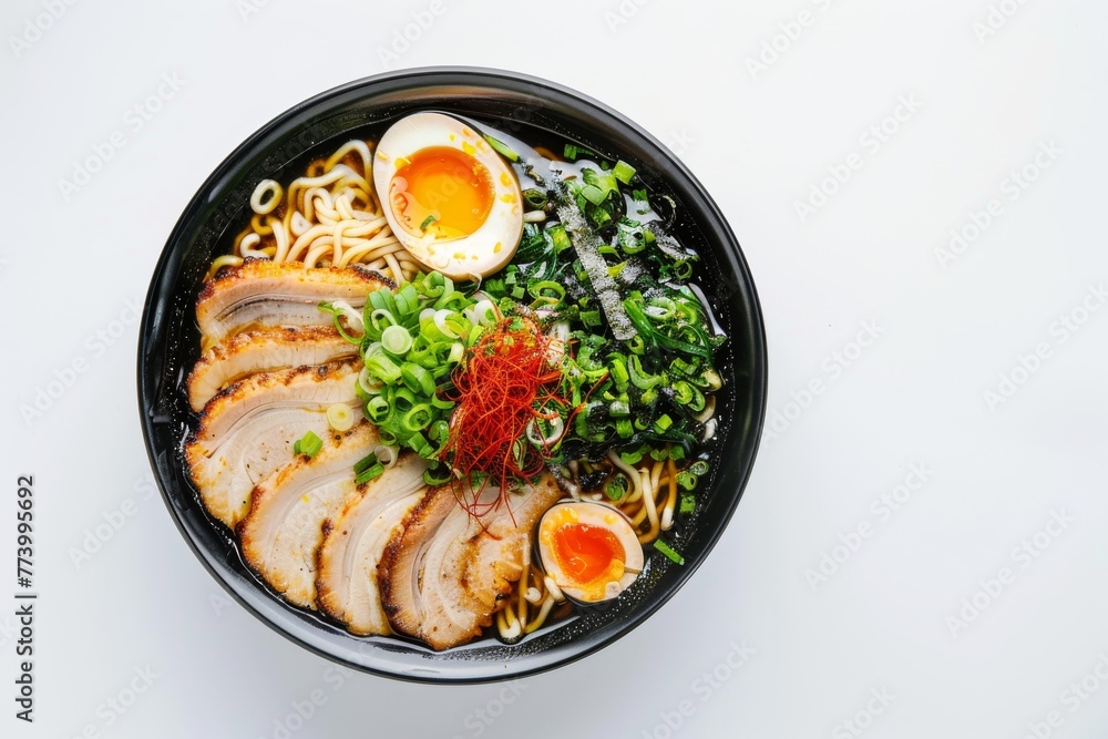 Asian ramen noodles on a black plate on a white background. Egg noodles, eggs, meat, seaweed. Empty space Asian ramen noodles on a black plate on a white background. Egg noodles, eggs, meat, seaweed. Empty space