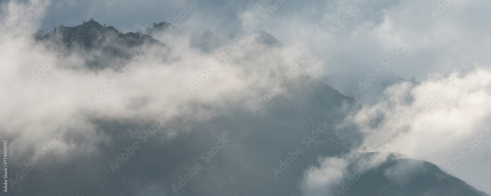 Mountain peaks in the clouds, foggy morning	