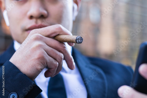 Cropped businessman smoking cigar