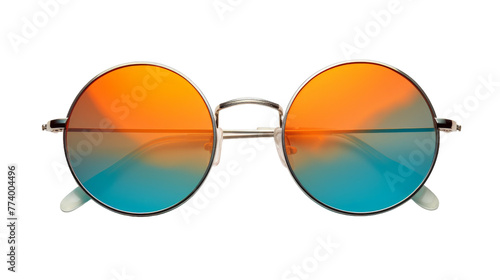 A pair of sunglasses resting on a surface, one lens tinted orange and the other tinted blue