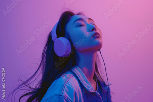 Asian girl enjoying music in studio