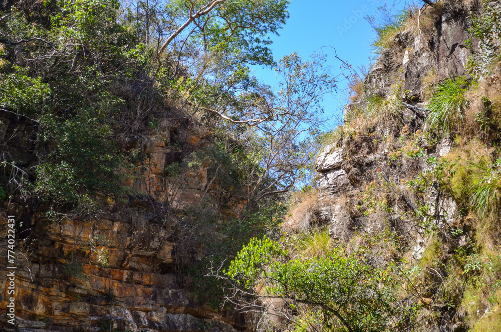 Huge canyon formed by very high vertical walls, inside it runs a river that forms some waterfalls. It is located in Serra do Cipó, Brazil Huge canyon formed by very high vertical walls, inside it runs a river that forms some waterfalls. It is located in Serra do Cipó, Brazil