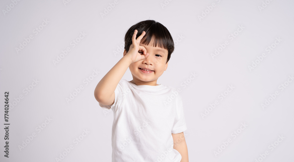 Portrait of an Asian boy posing on the white background Portrait of an Asian boy posing on the white background