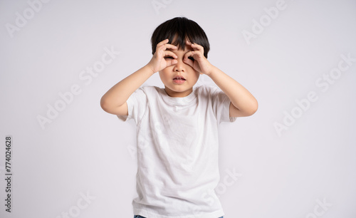 Portrait of an Asian boy posing on the white background