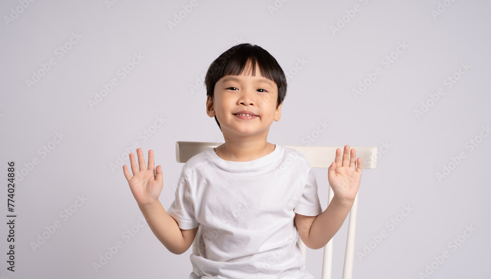 Portrait of an Asian boy posing on the white background Portrait of an Asian boy posing on the white background