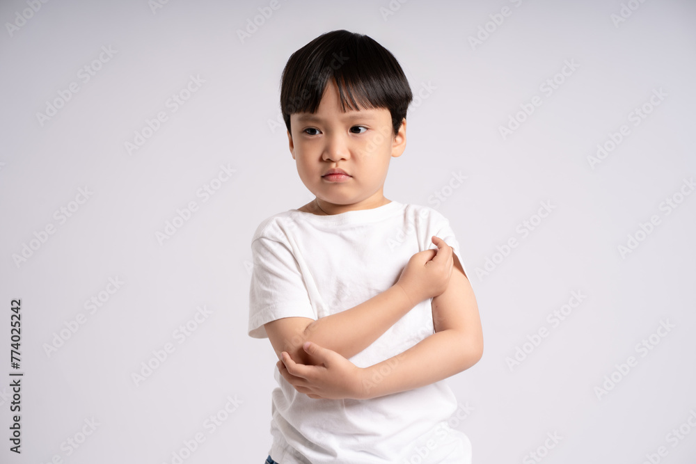 Portrait of an Asian boy posing on the white background Portrait of an Asian boy posing on the white background