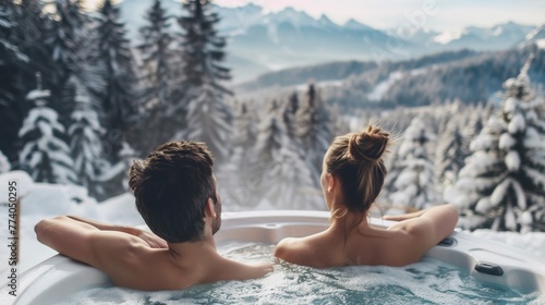 Couple relaxing in hot tub with winter mountain view