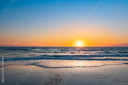 Vibrant sunset over the serene ocean waves. Naples Beach, Florida