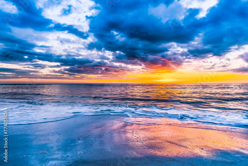 Vibrant sunset over the serene ocean. Naples Beach, Florida © Wirestock