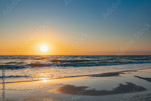 Scenic sunset over the beach and waves. Naples Beach, Florida