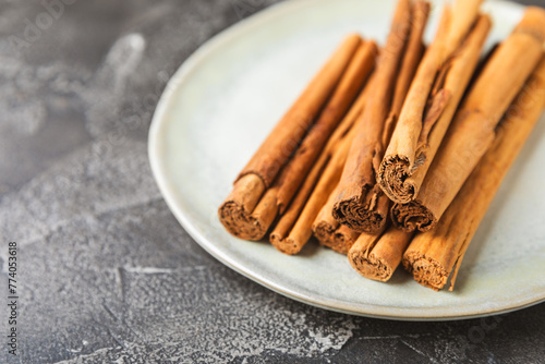Ceylon cinnamon.Cinnamon sticks on a textured wooden background. Cinnamon roll and powder. Spicy spice for baking, desserts and drinks. Fragrant ground cinnamon. Close-up. Place for text. copy space