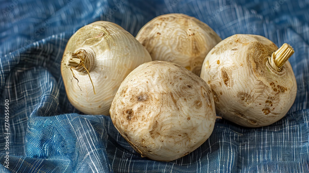 Mexican Turnip Fruit, also known as Jicama or Yam Bean, on blue fabric background
