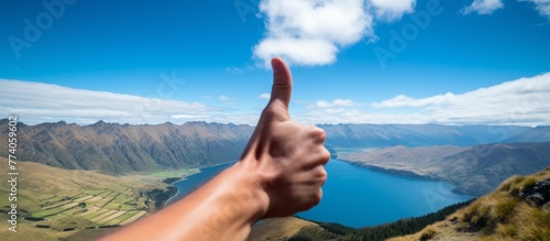 A close-up image of a hand giving a thumbs up gesture, signaling approval and positivity photo