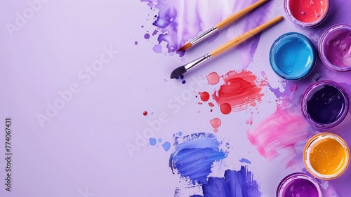 Open paint cans and brushes with colorful splashes strokes on a purple background