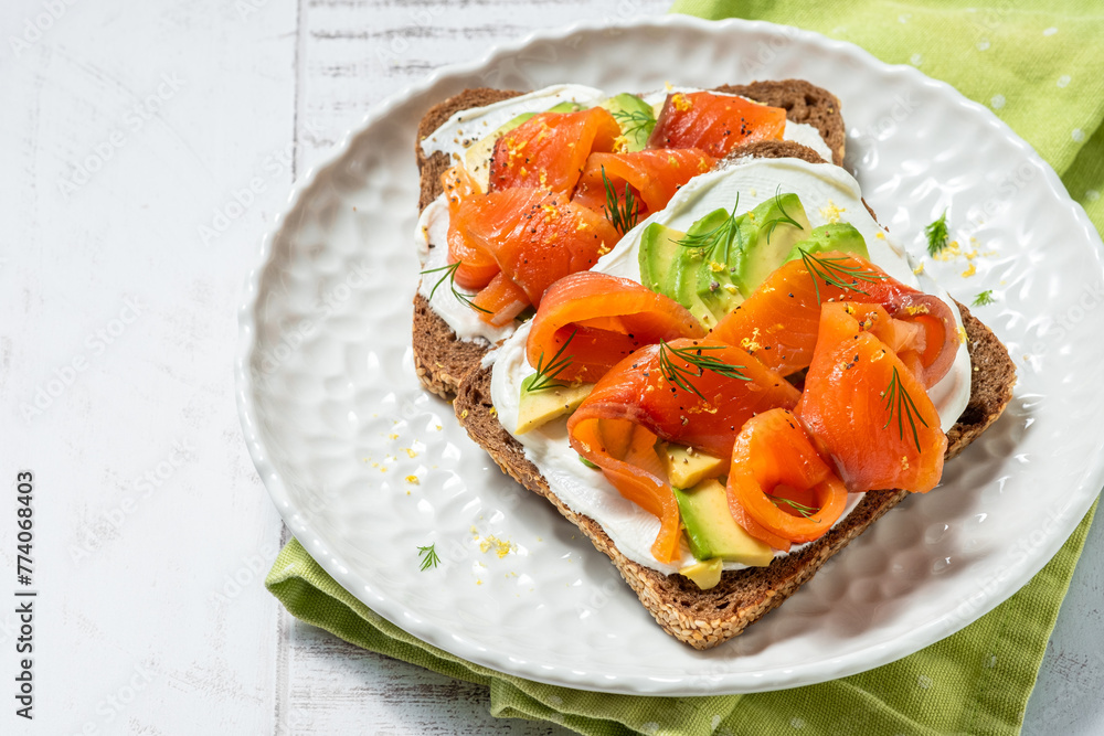 Two open sandwich, toast with salmon, cream cheese, avocado Two open sandwich, toast with salmon, cream cheese, avocado