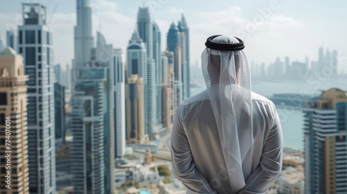 Rear View Of A Arabic Man Standing In Front Of Business Bay and skyscrapers