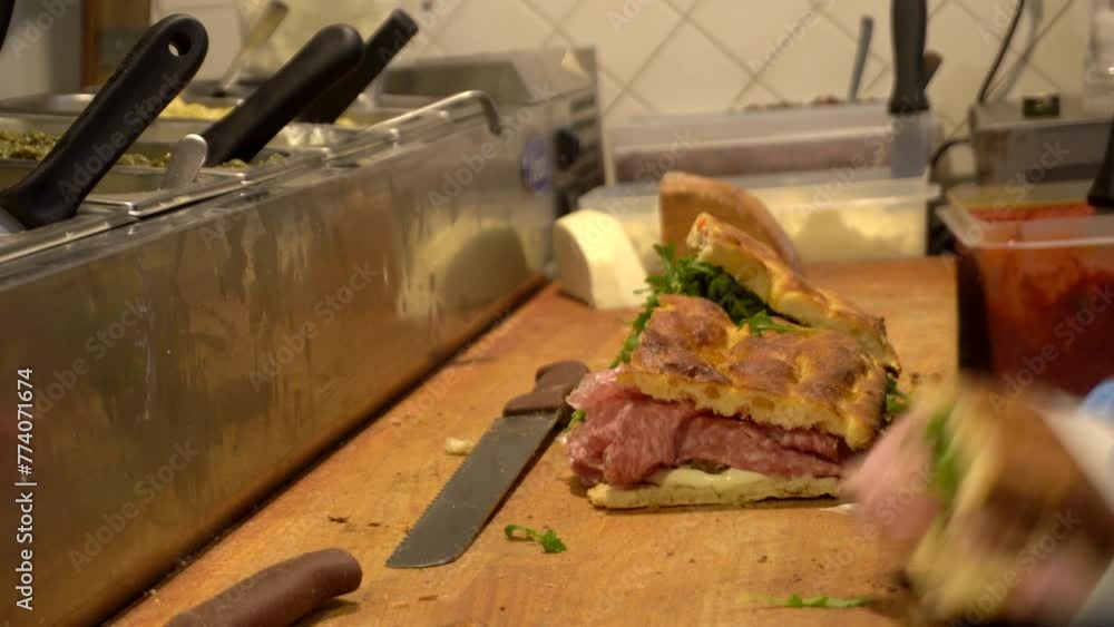 Freshly chef cook Italian sandwich in Florence bread salami slice meat vegetable and sauce Freshly chef cook Italian sandwich in Florence bread salami slice meat vegetable and sauce