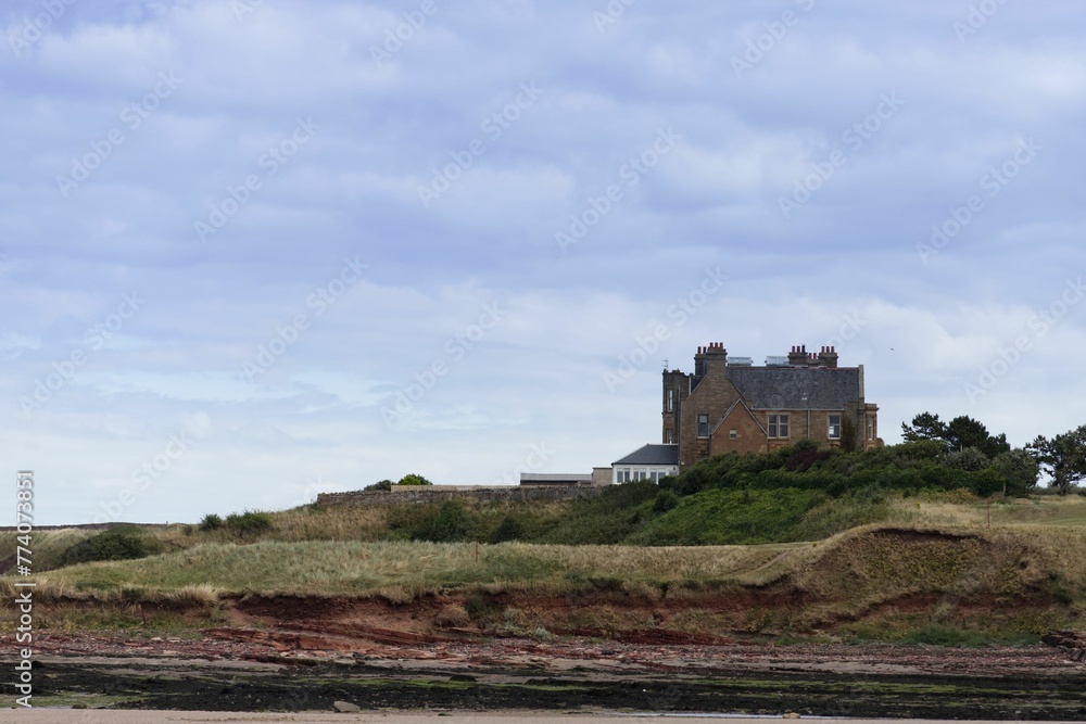 Historic brick house on a grassy cliff in North Berwick, Scotland, UK Historic brick house on a grassy cliff in North Berwick, Scotland, UK
