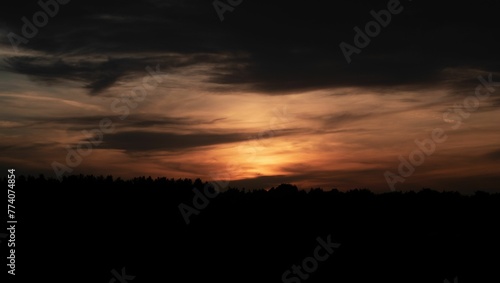 Beautiful sunset with an orange cloudy sky in the background