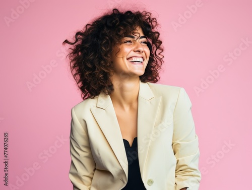 A woman is smiling and wearing a color clothing