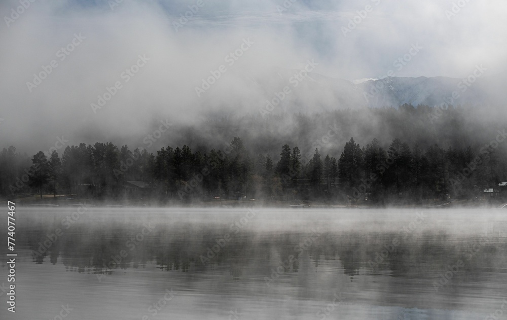 Beautiful view of the foggy Wasa Lake with trees in the background Beautiful view of the foggy Wasa Lake with trees in the background