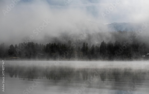 Beautiful view of the foggy Wasa Lake with trees in the background